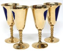 Group of four gilt metal wine glasses, 17cm high