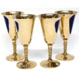 Group of four gilt metal wine glasses, 17cm high