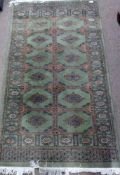 Small Bokhara type wool rug with medallion and geometric patterns in beige, white and black to a