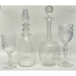 Two decanters, one with an air twist knop, the other with an engraved floral design, together with
