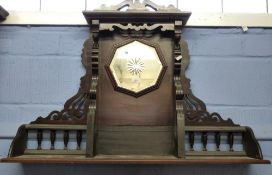 Late 19th/early 20th century American walnut framed overmantel with octagonal mirror to the back,