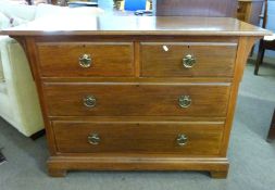 Late Victorian American walnut chest of two and two drawers with brass open horseshoe shaped drop