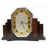 Art Deco mantel clock, in stepped wooden mount supported on metal feet with Roman numeral dial, 17cm