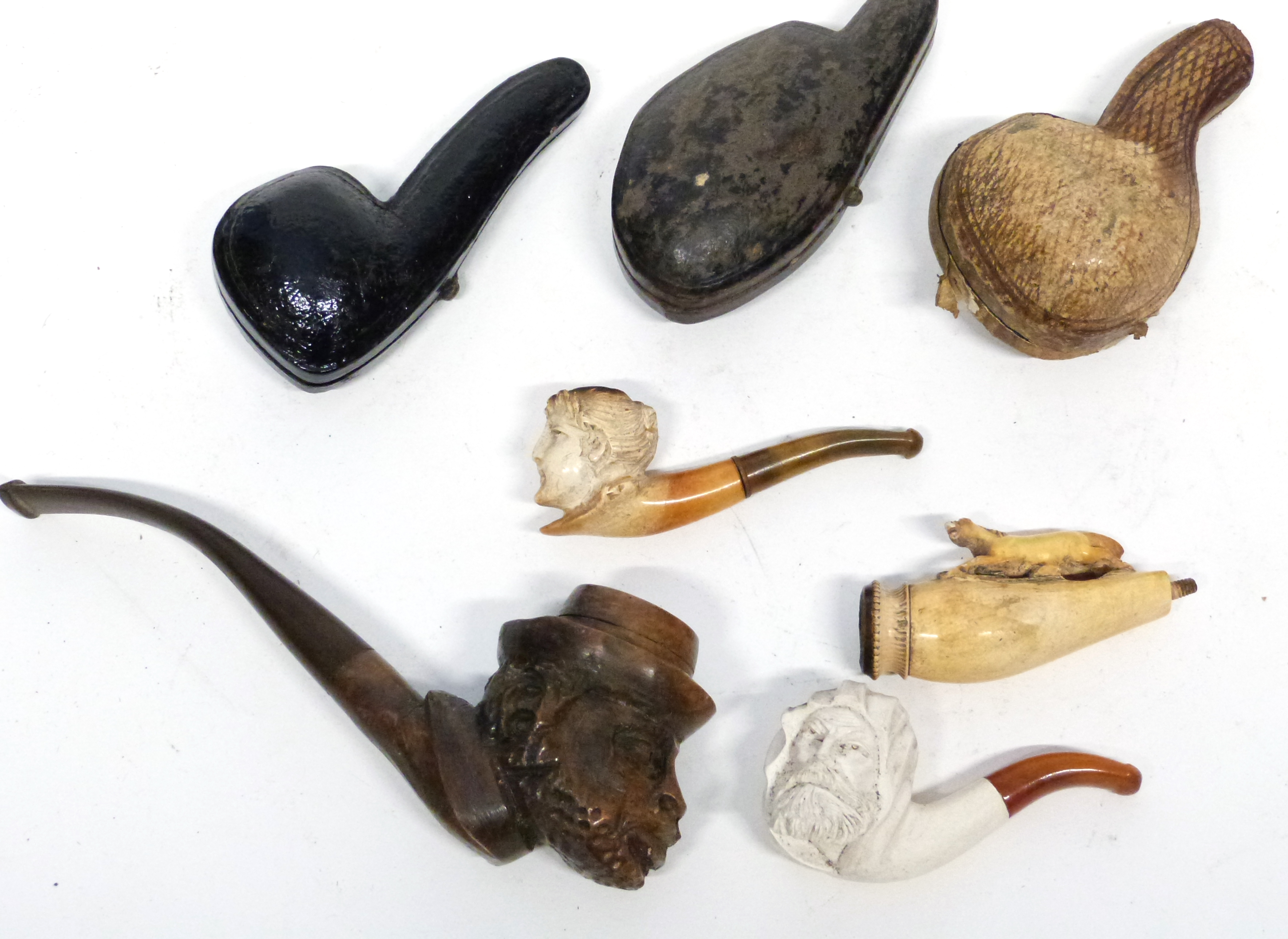 Small plastic case containing a Meerschaum type pipe and leather pipe cases (5)