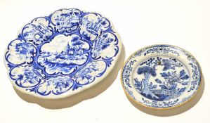 Dutch Delft plate with a floral design within ochre rim, together with a further Delft or German