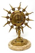 Gilt metal clock, the face inlaid with red stones bordered by symbols of the Zodiac, clock mounted