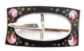 Silver and enamel "buckle brooch" of rectangular pierced shape on black ground enamel detail with