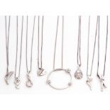 Mixed Lot: eight modern white metal pendant necklaces, each highlighted with a single cut diamond(