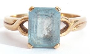 9ct gold modern blue stone ring, rectangular shaped stepped cut, raised between pierced shoulders,