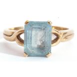 9ct gold modern blue stone ring, rectangular shaped stepped cut, raised between pierced shoulders,