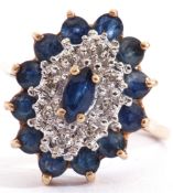 Sapphire and diamond cluster ring of lozenge shape, centring a marquis cut faceted sapphire,