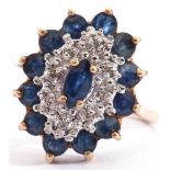 Sapphire and diamond cluster ring of lozenge shape, centring a marquis cut faceted sapphire,