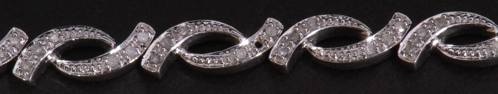 Modern small diamond set bracelet, an oval link design, each with three small graduated diamonds, - Image 6 of 6