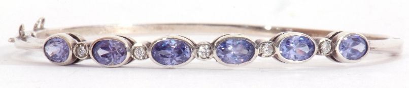 Modern pale sapphire and diamond set hinged bracelet, featuring six oval faceted pale sapphires in