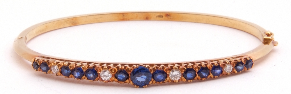 Sapphire and diamond hinged bracelet, the raised pierced gallery set with 13 round faceted sapphires