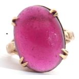 Yellow metal and pink cabochon stone ring, the large pink cabochon four claw set and raised in a