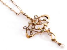 Art Nouveau open work pendant in a stylised yellow scroll mount highlighted with seed pearls and