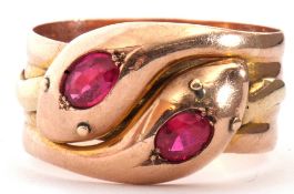 Large 9ct gold ruby set serpent ring, a design featuring two coiled snakes with their heads set with