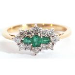 An emerald and diamond cluster ring, centring three small stepped cut emeralds within a small