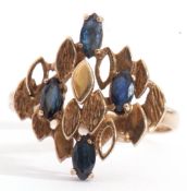 9ct gold and sapphire designer ring, having four marquis shaped faceted sapphires set amongst