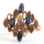 9ct gold and sapphire designer ring, having four marquis shaped faceted sapphires set amongst