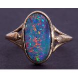 9ct gold and opal ring, the oval shaped opal doublet in rub-over setting and raised between split