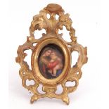 An oval hand painted miniature on porcelain depicting a mother and child in an ornate carved