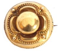 Victorian gold Etruscan revival target brooch, typically decorated with bead work and scroll