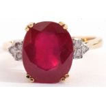 18ct gold, ruby and diamond ring, the large oval faceted ruby four claw set and raised between small