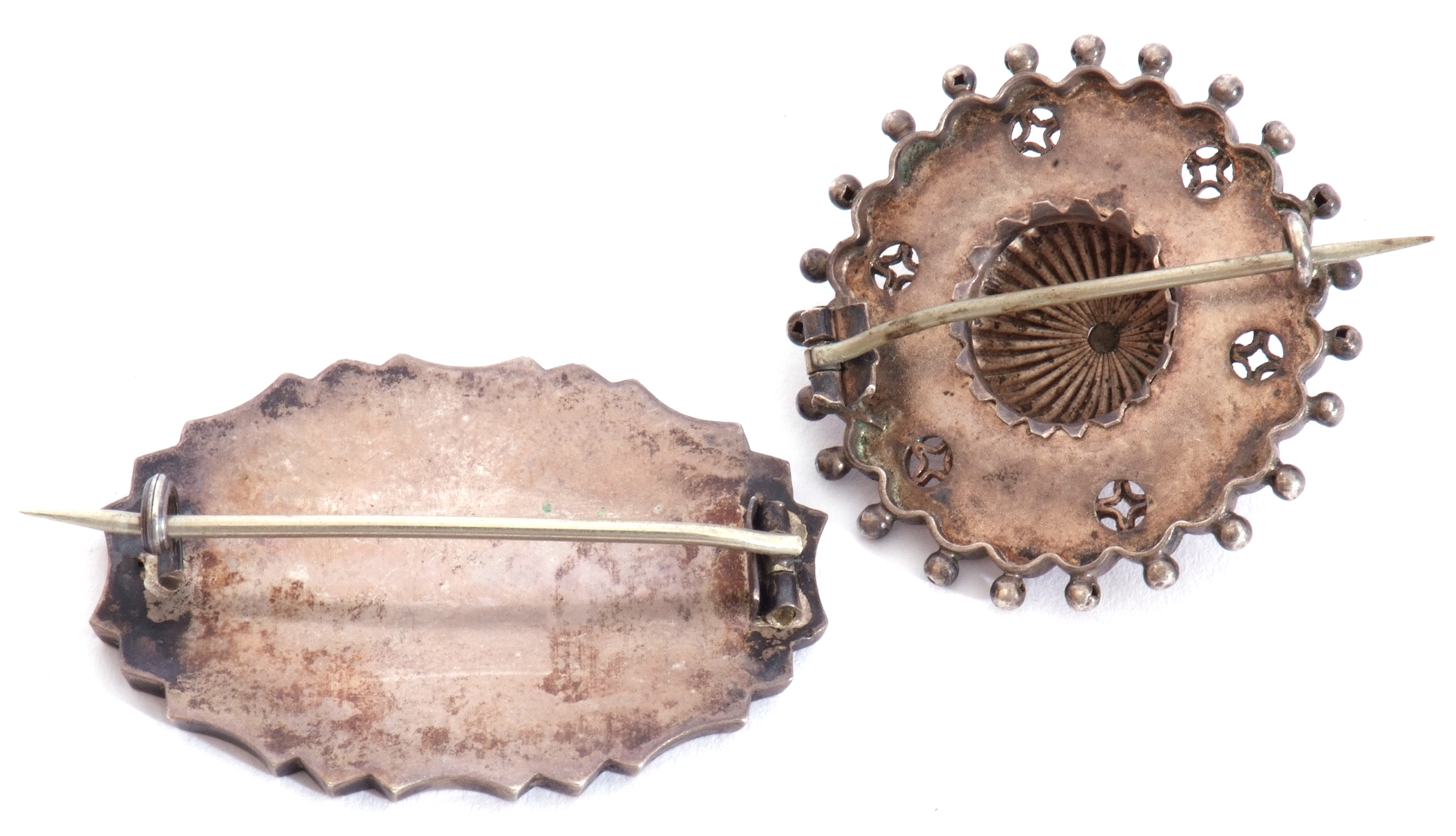 Mixed Lot: two vintage white metal pressed brooches, one of oval shape, the centre with an - Image 2 of 2