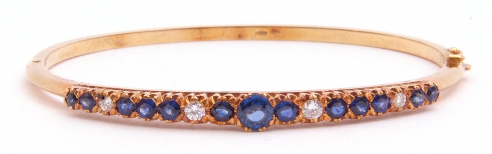 Sapphire and diamond hinged bracelet, the raised pierced gallery set with 13 round faceted sapphires - Image 6 of 6