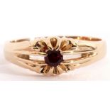 Single stone ring, the split shank centring a small round cognac citrine, plain polished mount