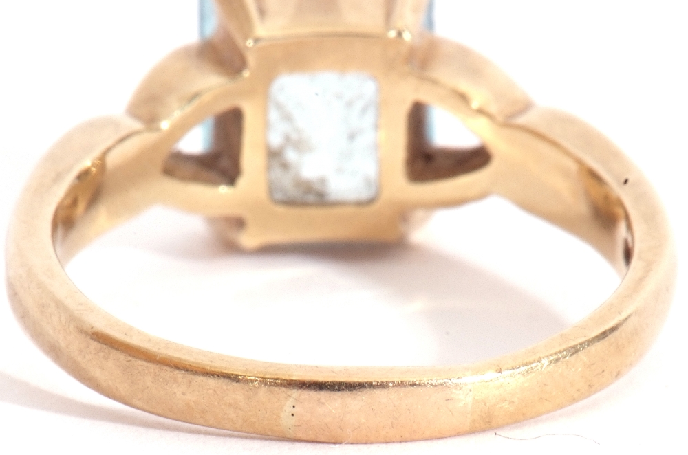 9ct gold modern blue stone ring, rectangular shaped stepped cut, raised between pierced shoulders, - Image 4 of 7