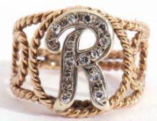 Modern yellow metal and diamond letter "R" ring, centring a letter R set with small single cut