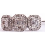 Modern 9ct white gold and diamond cluster ring, a design featuring three shaped square panels,