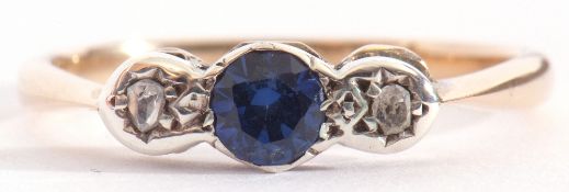 Sapphire and diamond three stone ring centring a small round cut sapphire flanked by small old cut