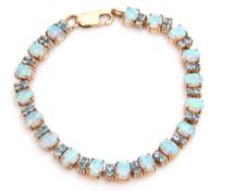 Modern 375 stamped opalescent and blue stone set articulated bracelet, a design featuring eighteen