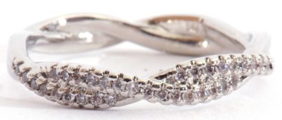 Modern precious metal and diamond cluster ring, a design featuring two entwined bands set with small