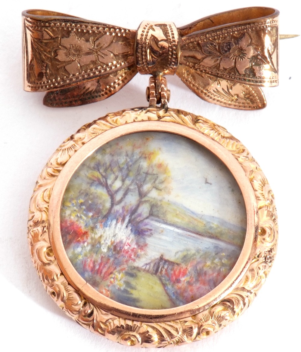 Antique double sided locket, one side painted with a garden river view scene, in ornate chased and