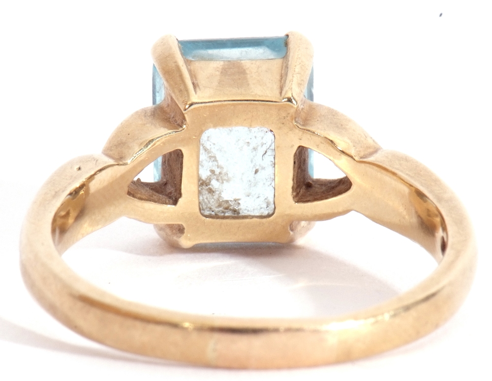 9ct gold modern blue stone ring, rectangular shaped stepped cut, raised between pierced shoulders, - Image 3 of 7