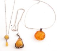 Mixed Lot: pressed amber pendant on a 925 marked bale on a choker style necklace, a modern amber