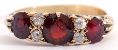 Antique garnet and diamond ring, having three graduated oval faceted garnets (centre stone cracked),