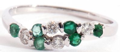 Modern precious metal diamond and emerald ring, alternate entwined design featuring 4 small