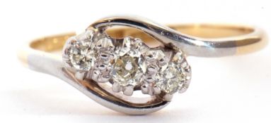 Three-stone diamond cross-over ring featuring three graduated brilliant cut diamonds, 0.20ct approx,
