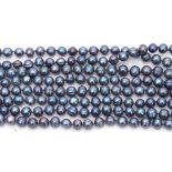 Long continuous row of dyed dark grey pearls with green and purple overtones, off round to oval