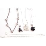 Mixed Lot: Two 925 stamped pendants on chains, each with black stone decoration, a pierced square