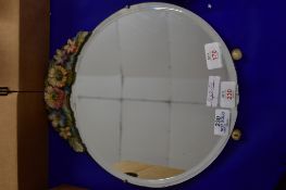 CIRCULAR MIRROR WITH FLORAL DESIGN ABOVE