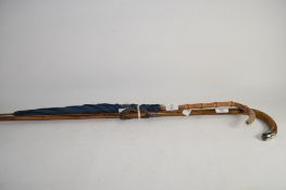 WALKING CANE WITH SILVER METAL TOP TOGETHER WITH AN UMBRELLA WITH WOODEN BAMBOO TYPE HANDLE