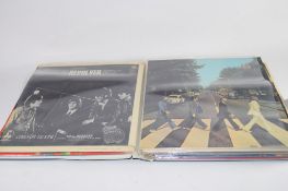 FOLDER CONTAINING BEATLES LPS INCLUDING SGT PEPPERS LONELY HEARTS CLUB, REVOLVER ETC