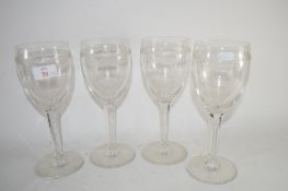 FOUR LARGE GLASSES WITH FACETED STEMS ENGRAVED "AES"
